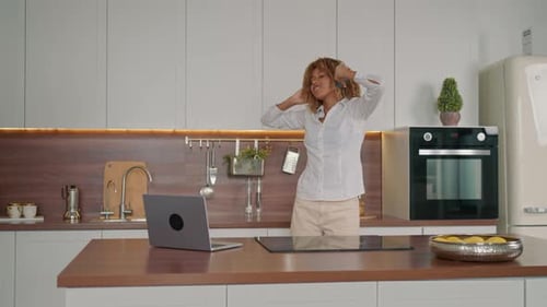 Woman Dancing in Kitchen