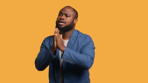 Man with hands together in front of face