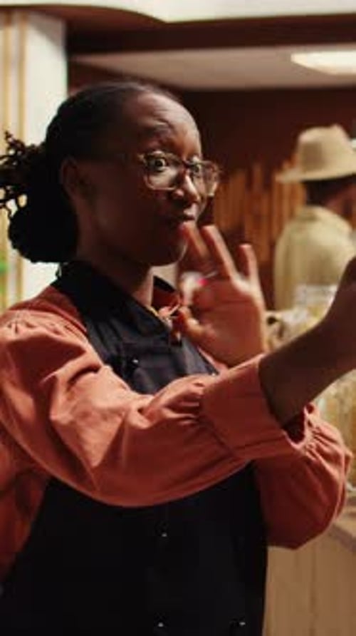 Vertical Video Zero Waste Store Employee Filming Their Natural Products in Recyclable Jars