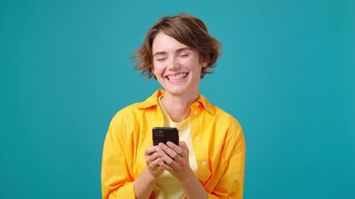 Joyful Woman Smiles Chatting on Social Networks on Phone