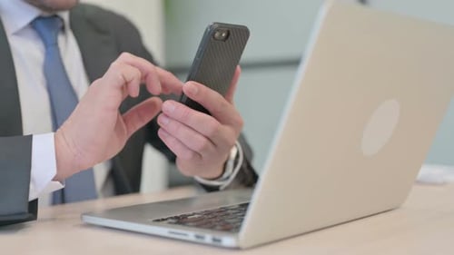 Close Up of Businessman Hands Using Smartphone