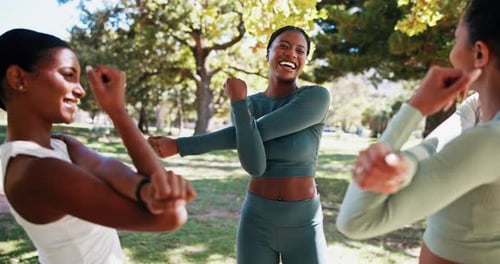 Young Adults Stretching Together in Park