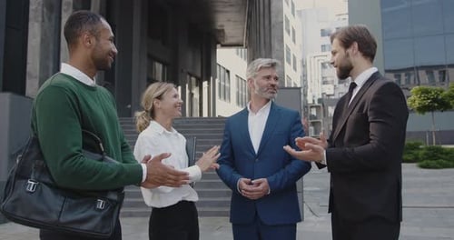 Cheerful Businesspeople Meeting and Shaking Hands Outdoors