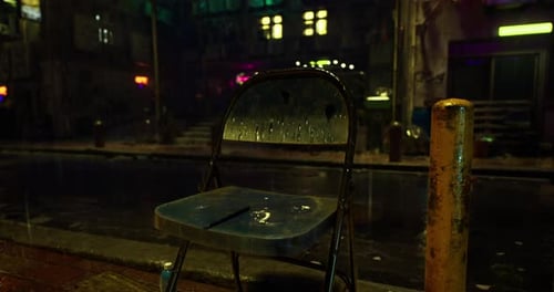 Urban Street Corner with a Rain Soaked Chair During Nighttime Ambiance