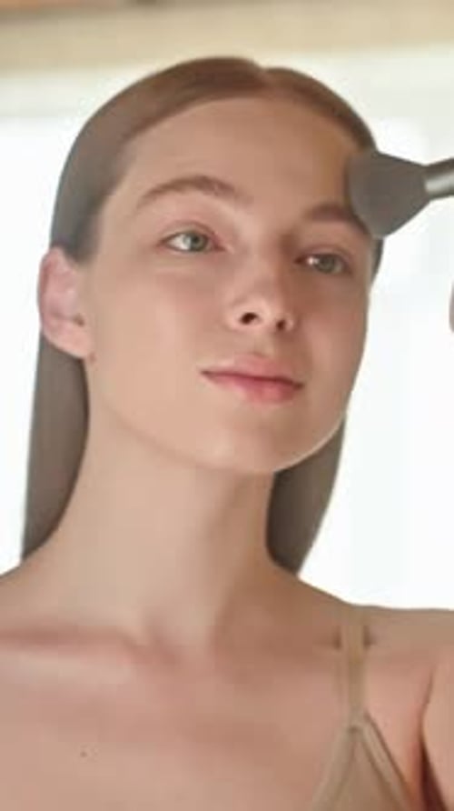 Woman Applying Makeup with Brush for Beauty