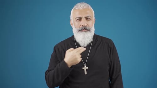 The Christian man also makes the sign of the cross. Close-up of Christian man.