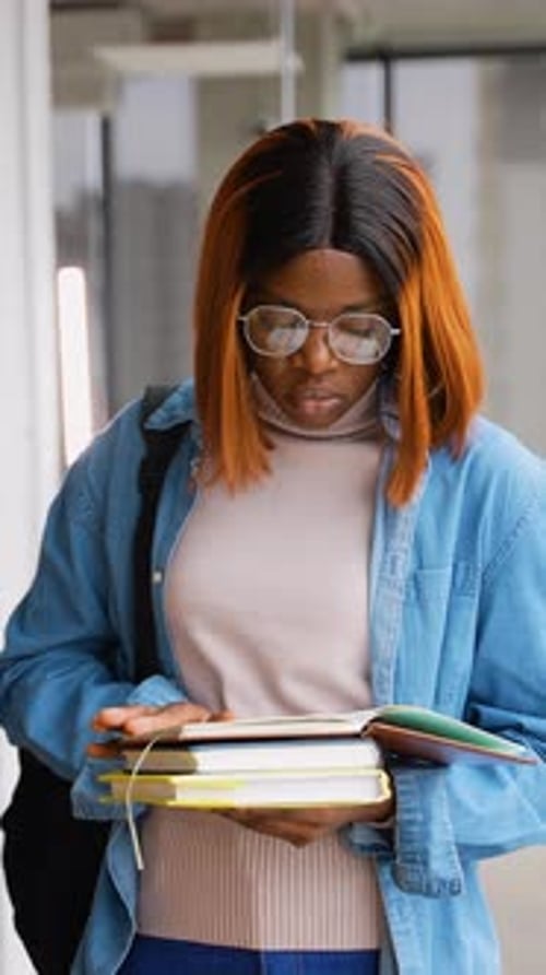African American Student Reading Book in Library