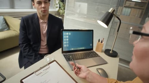 Female HR Executive Interviewing Young Male Job Seeker for Office Position