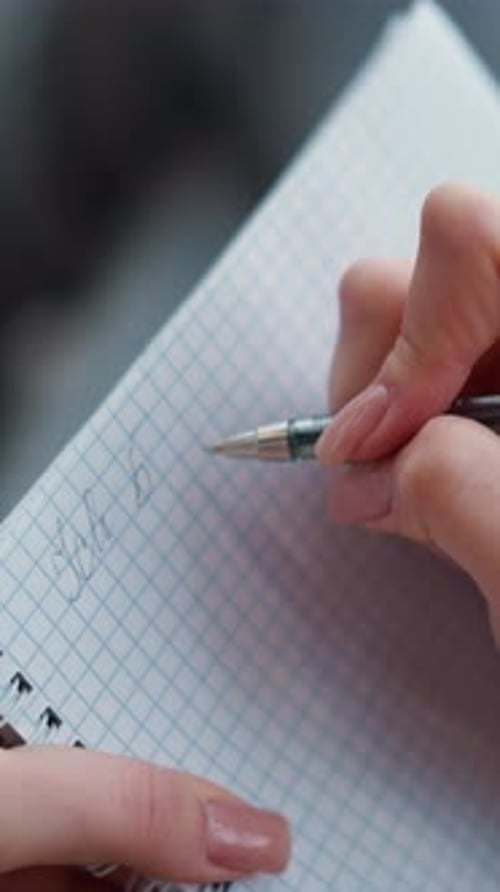CloseUp Hand View of Lady Writing in Notebook with Pen