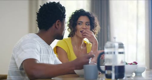 Cheerful, smiling and carefree boyfriend and flirty girlfriend enjoying good food