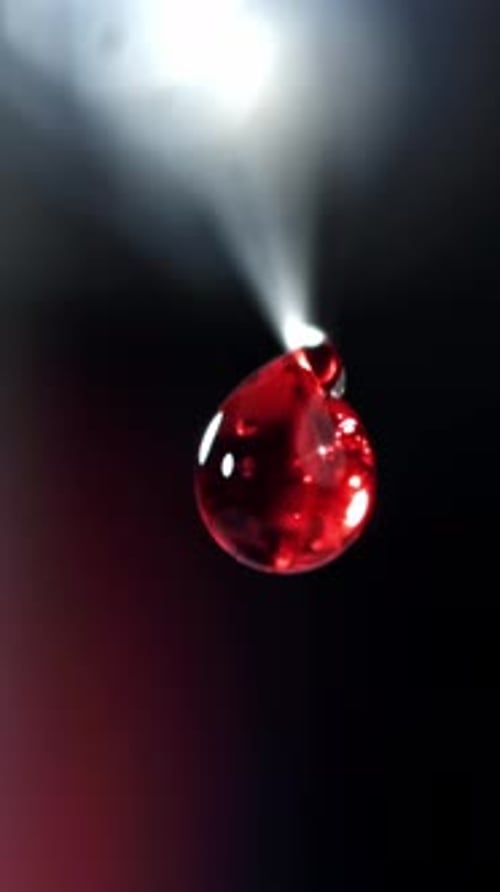 A Drop of Blood From a Syringe Filmed on a Highspeed Camera at 1000 Fps