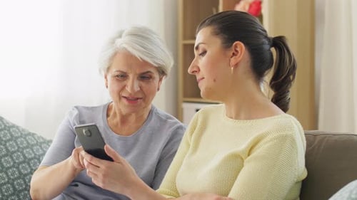 Senior Woman and Adult Woman Looking at Phone