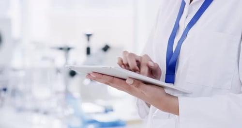 Lab Worker Uses Tablet in Bright Workplace