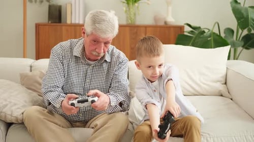 Grandfather and Grandson Playing Video Games Together