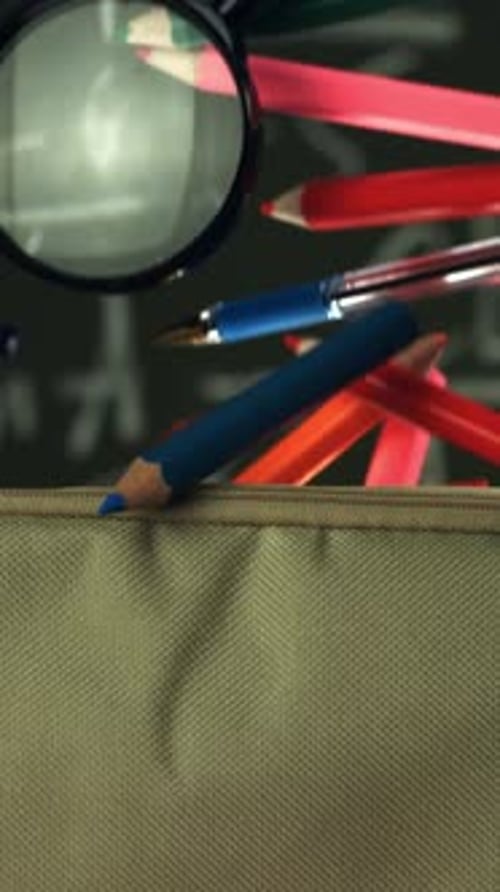 Various Accessories Fall Into the School Pencil Case Filmed on a Highspeed Camera at 1000 Fps