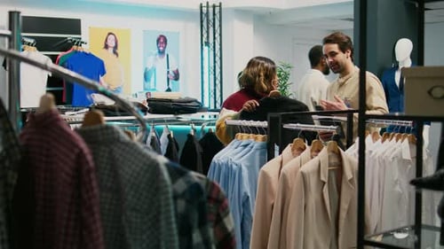 Store Assistant Helping African American Client with Clothes