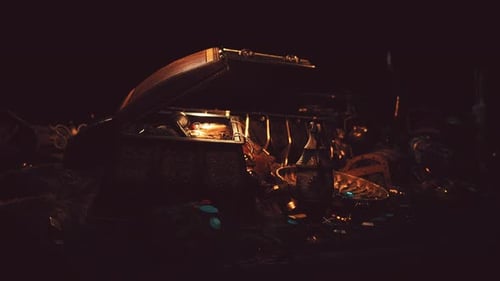 Handful of Gold Jewelry on a Dark Background