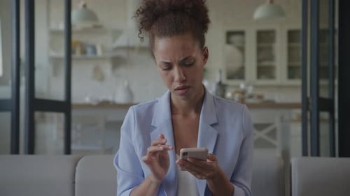 Woman Rubs Temples After Using Her Phone