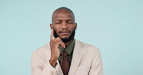 Thinking, idea and happy black man in studio with questions, solution and strategy on blue