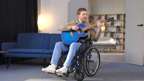 Man in Wheelchair Plays Guitar and Sings