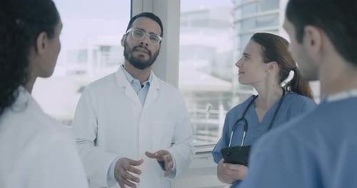 Doctor Talking with Medical Team in Hospital corridor