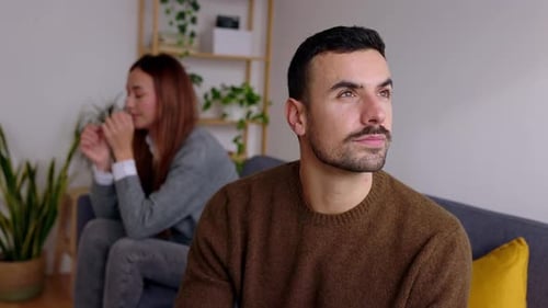 Distressed Couple Experiencing Conflict in Their Home
