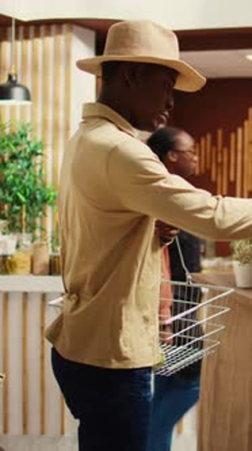 Vertical Video African American Client Shopping for Pasta or Grains in Jars