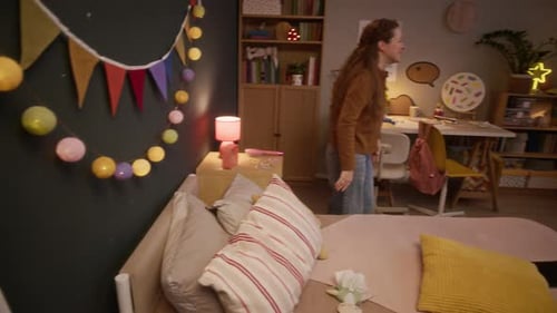 Woman and Girl Playing with Balloon in Bedroom