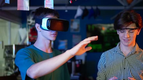 Young Adult Using VR Headset in Workshop