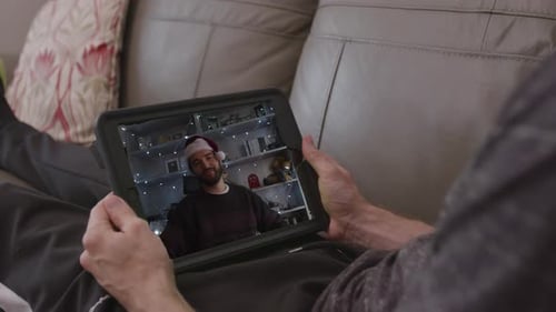 Person On Tablet Video Chat Wearing Santa Hat