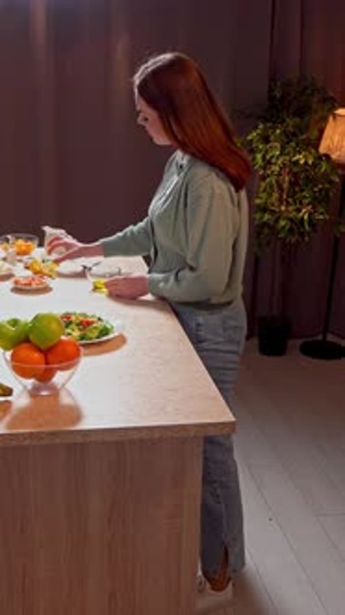 Woman Prepares Light Meal in her Kitchen