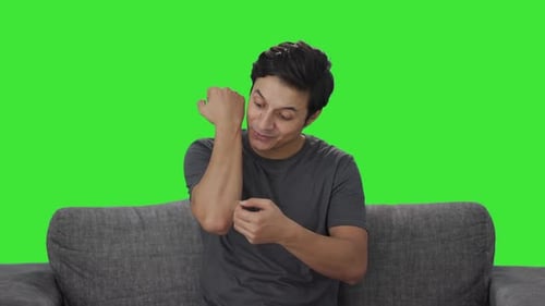 Indian man removing the bandage from hand Green screen