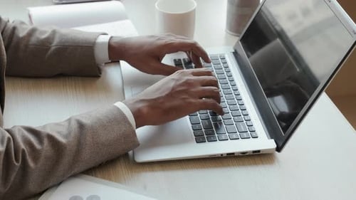 Typing on Laptop in Bright Office Setting