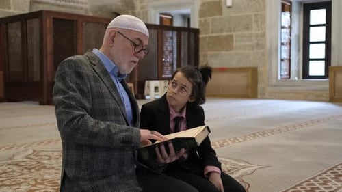 Man and Child Reading Book in Religious Building