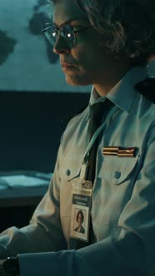 Female Officer Working on Computer in Command Center