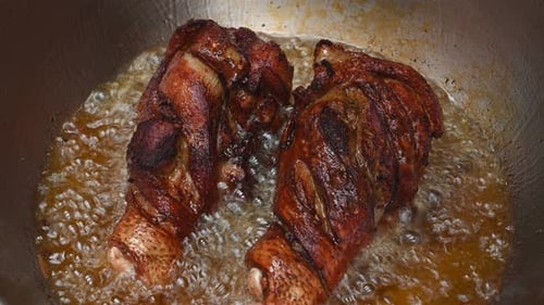 Already turned and still cooking the underside, golden brown fried meat inviting to a lovely meal; F