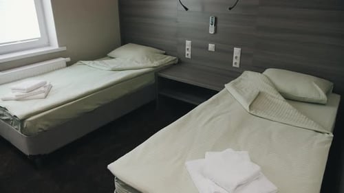 The bed is in the hotel. A two-bed room waiting for guests. Two made-up beds in the apartment.