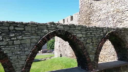 Medieval Bedzin castle with a turret, white stone walls, and courtyard during a beautiful summer day