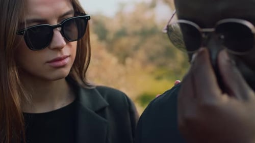 Young Woman Comforting Crying Man at Funeral Ceremony
