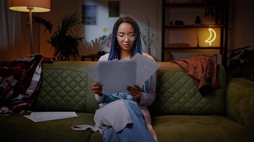 Thoughtful African Ethnic Young Woman Working on a Magazine Article Lack of Inspiration