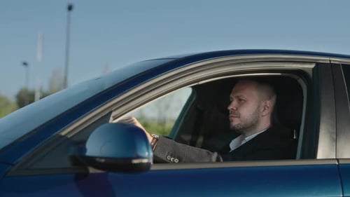 Businessman Drives His Car An Elegant Adult Man is Driving Home After Work