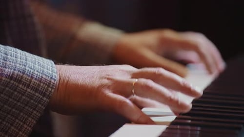 Close Up of Piano Keys Played Indoors