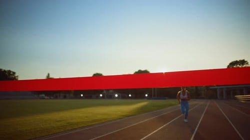 Beautiful Fit Female Runner Crossing the Finish Line on a Professional Sports Arena. Athletic Woman