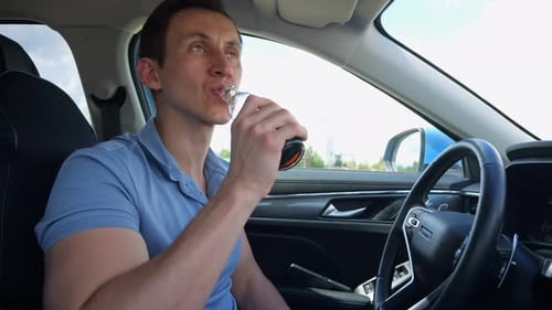Man Drinking Soda in Car