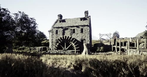 Historic Watermill Surrounded By Golden Wheat Fields on a Clear Day
