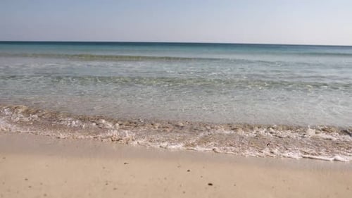 time lapse. sea blue waves break on an empty beach on sunny day. Sea waves and beautiful sand.