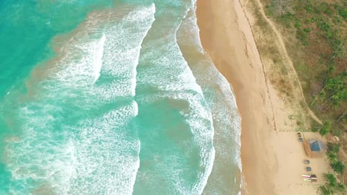 Aerial View of Tropical Sandy Beach and Blue Ocean Top View of Ocean Waves Reaching Shore on Sunny