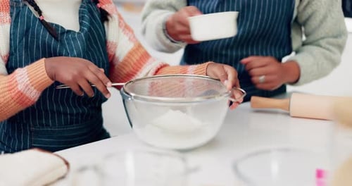 Girl and Woman Baking Together in Kitchen