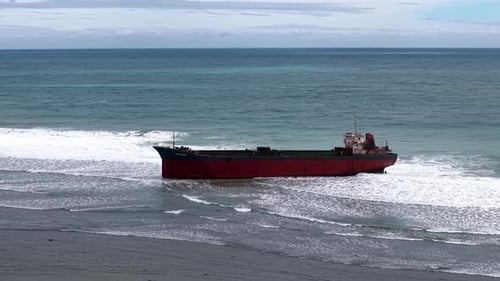 Aerial view, top view of old rusty stranded logistics ship on the beach