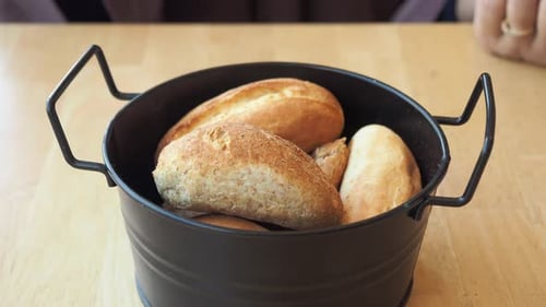 Woman Hand Pick Baked Bun on Table
